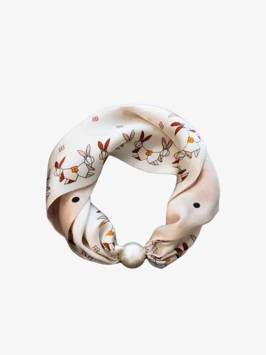 Floral patterned headband with a pearl on a white background