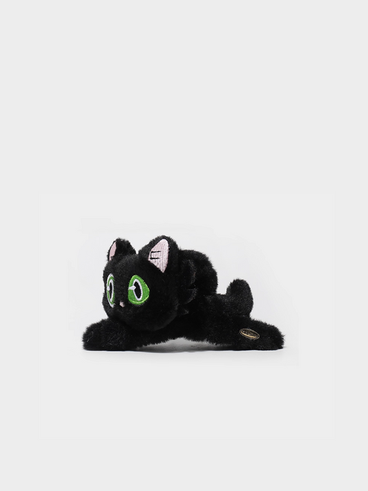 Black plush cat toy with green eyes on a white background