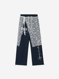 Navy blue and gray pants with star pattern and drawstring on a white background