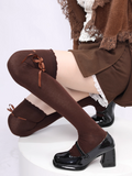 Brown knee-high socks with black shoes on a white background