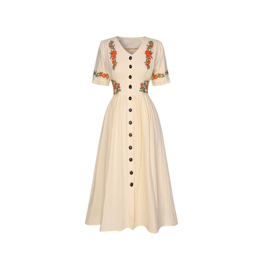 Beige dress with floral embroidery on a white background