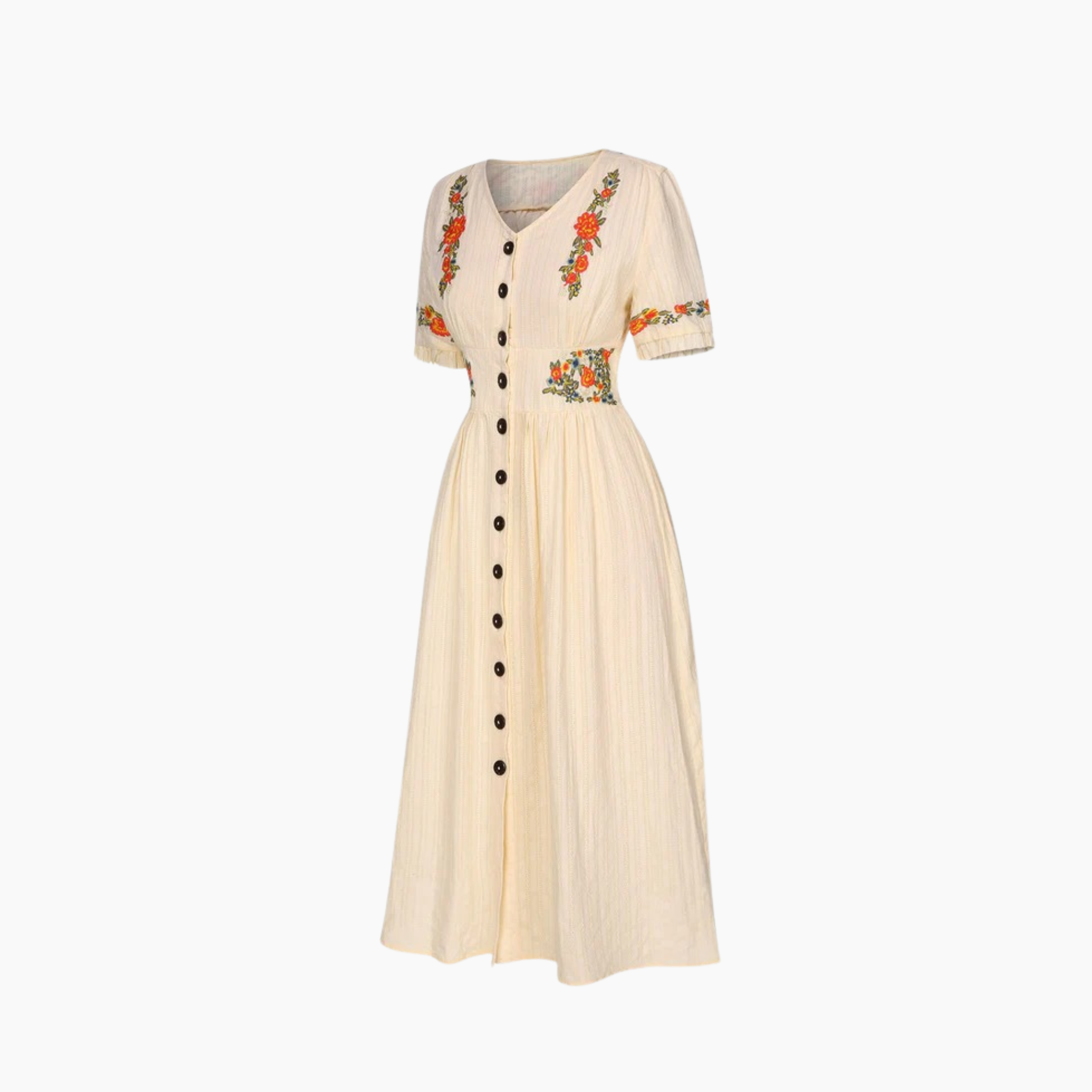 Beige dress with floral embroidery and black buttons on a white background