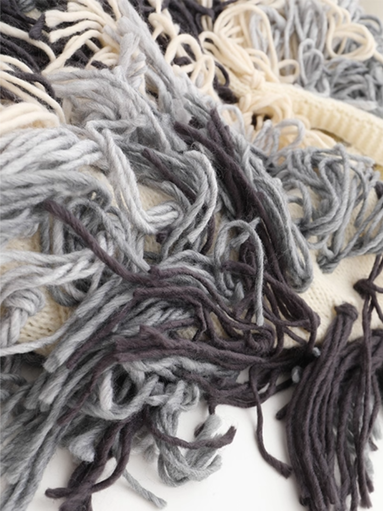 Close-up of textured yarn in various colors on a white background