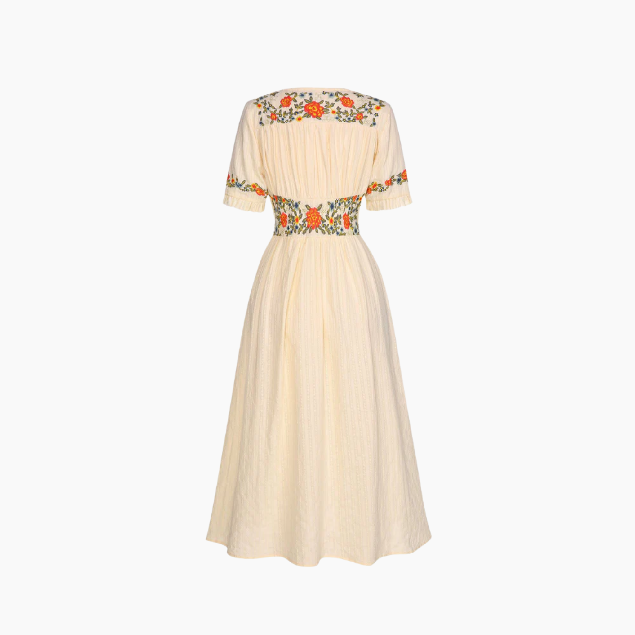Beige dress with floral embroidery on a white background