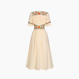 Beige dress with floral embroidery on a white background