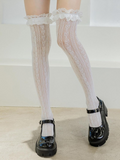 White lace tights worn with black shoes on a light background