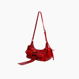 Red handbag with a strap on a white background
