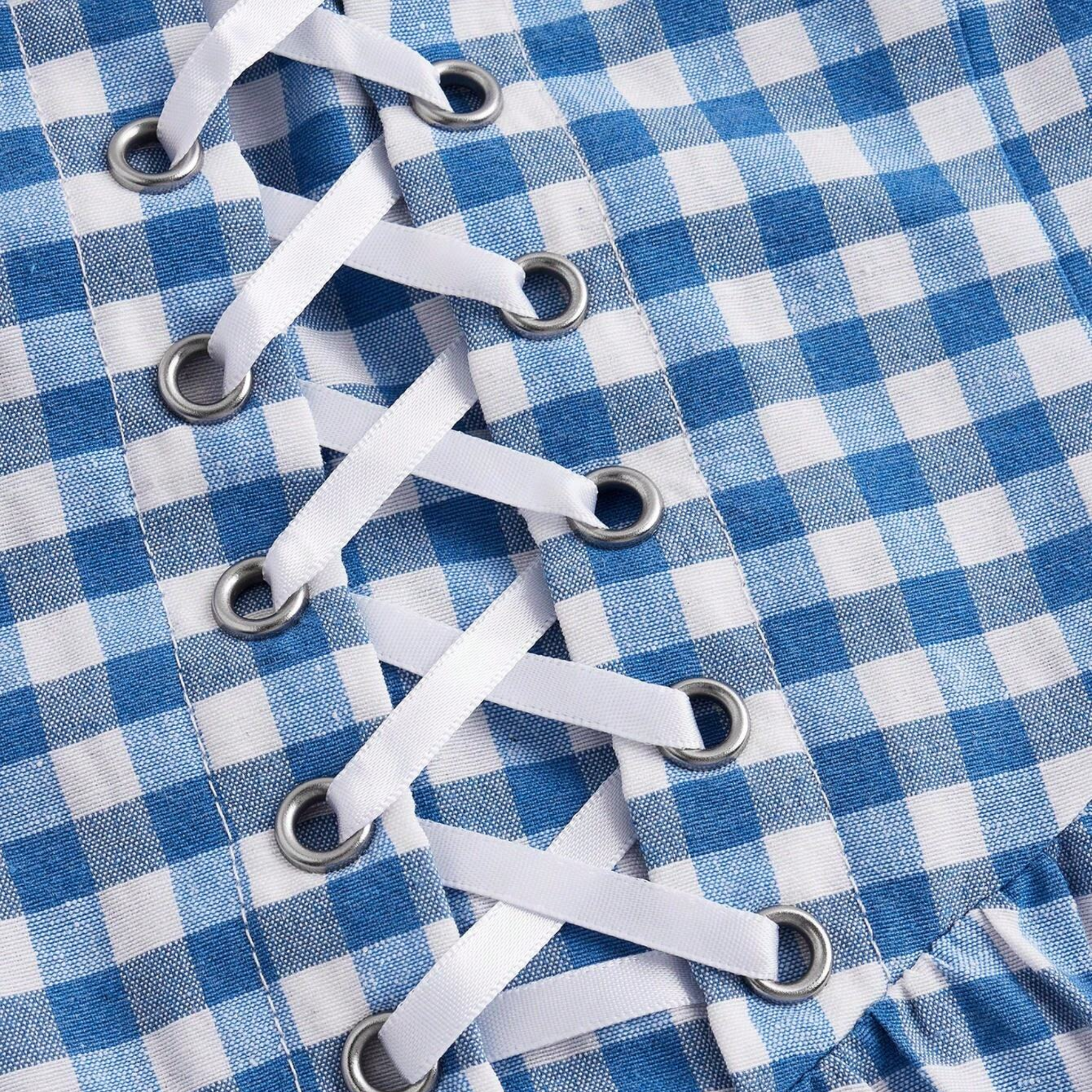 White shoelaces on a blue and white checkered fabric background
